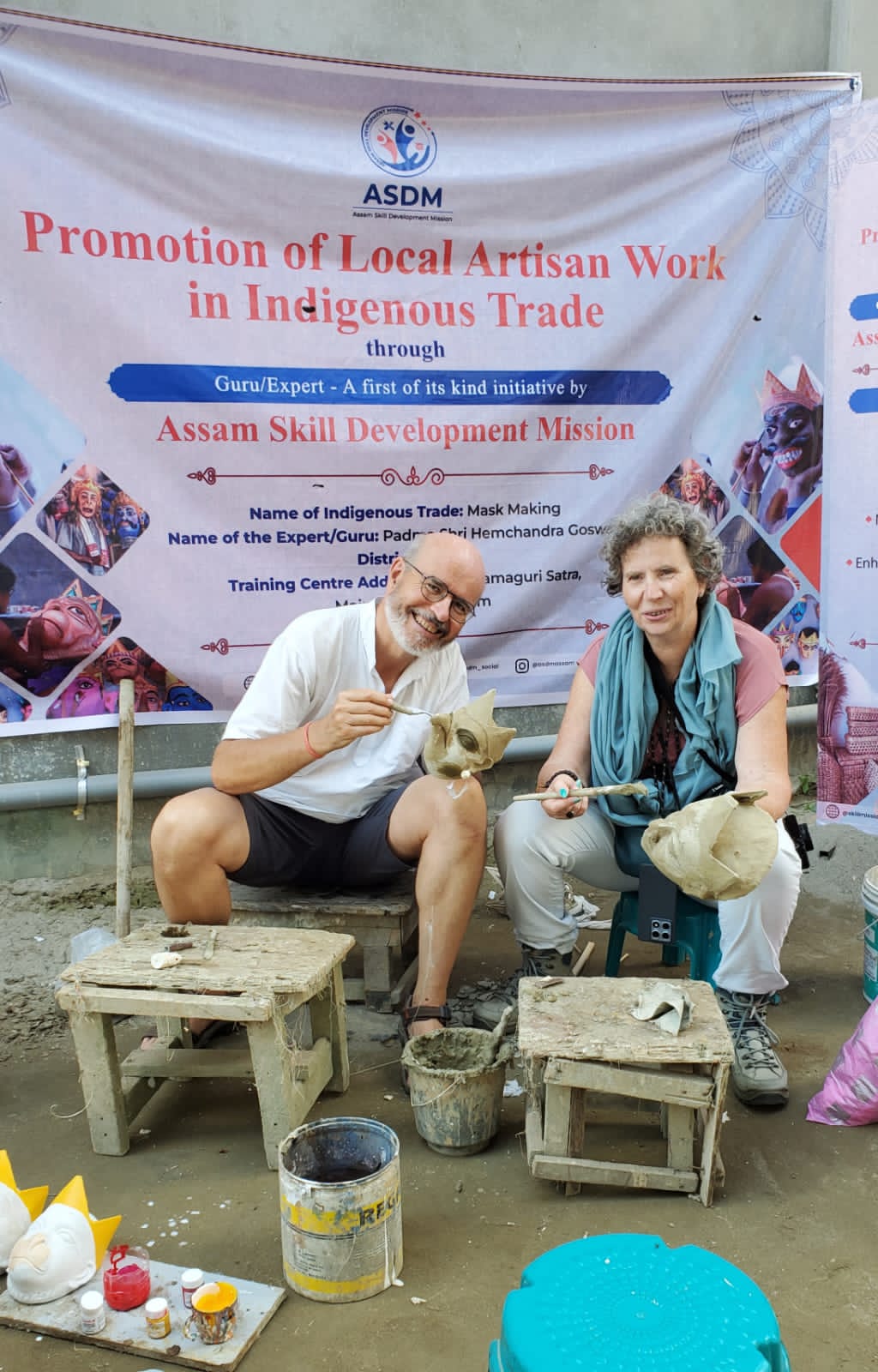 Robert and Odile painting traditional Assamese masks at the Samaguri Satra mask-making centre in Majuli