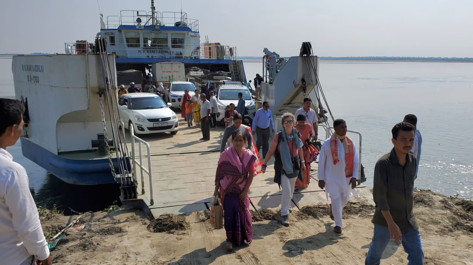 Passengers and vehicles disembarking the Brahmaputra ferry at Majuli island in Assam