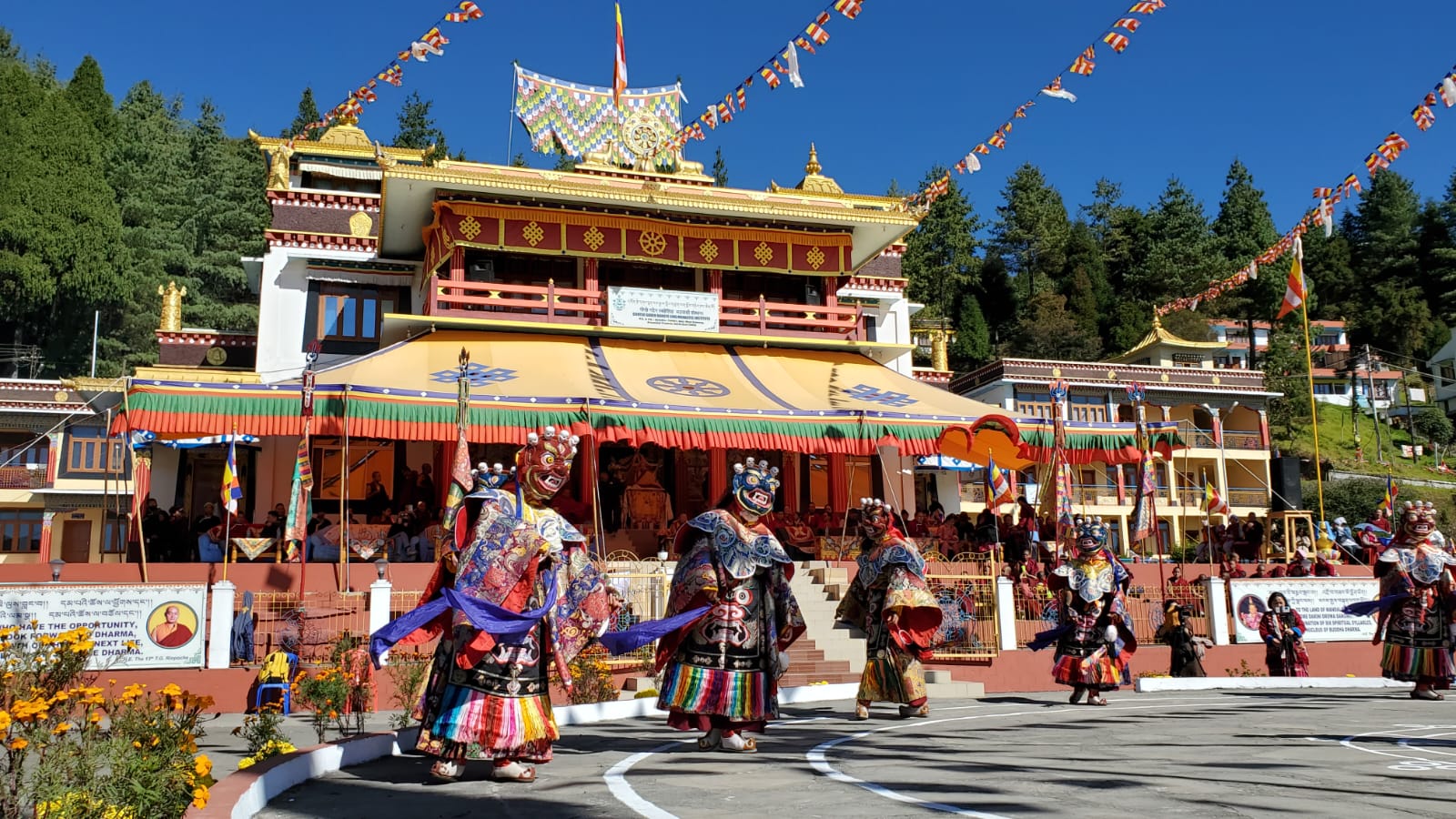 Masked cham dancers performing in the courtyard of a Buddhist monastery in Tawang, Arunachal Pradesh
