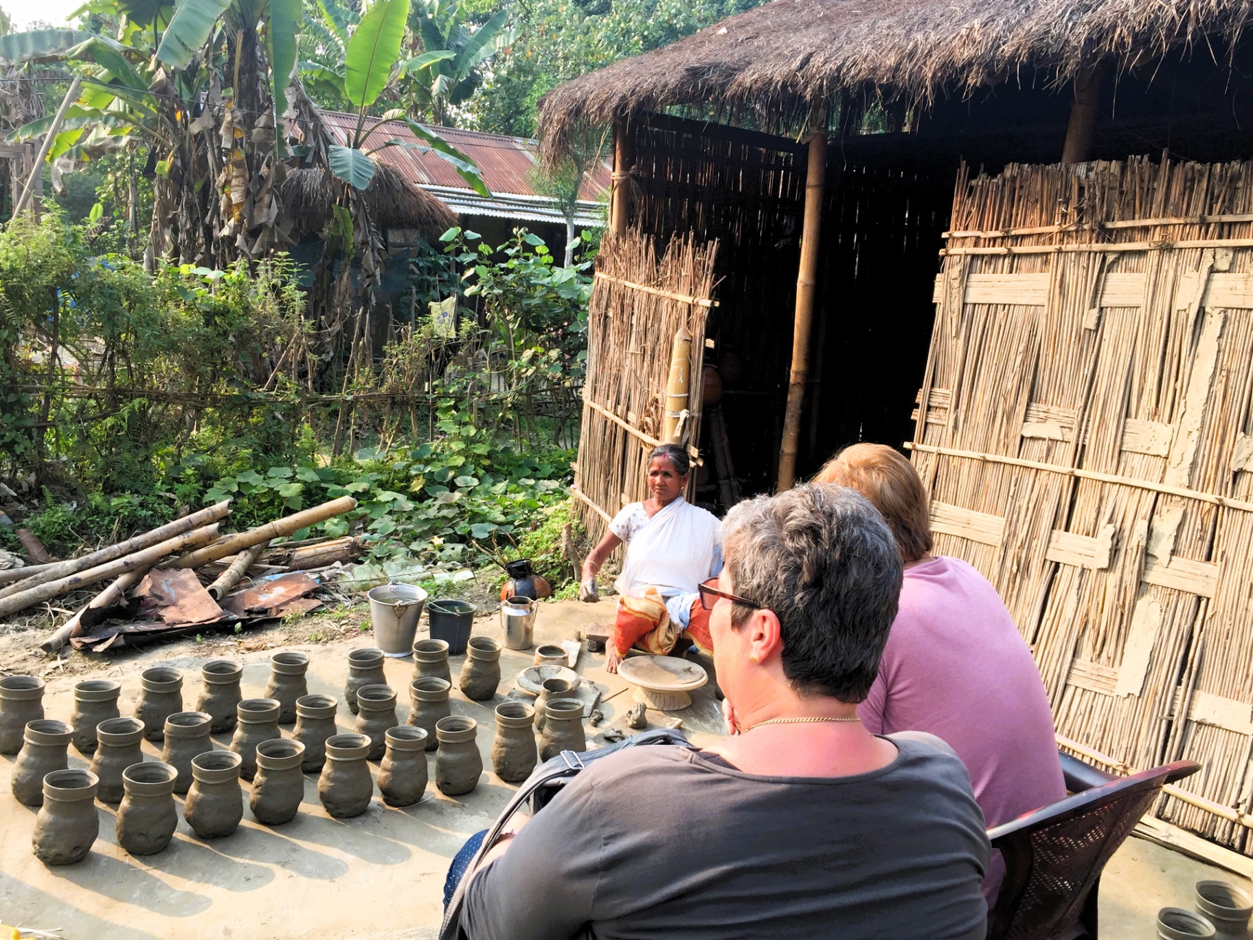 A pottery demonstration with Living Roots guests in rural Assam