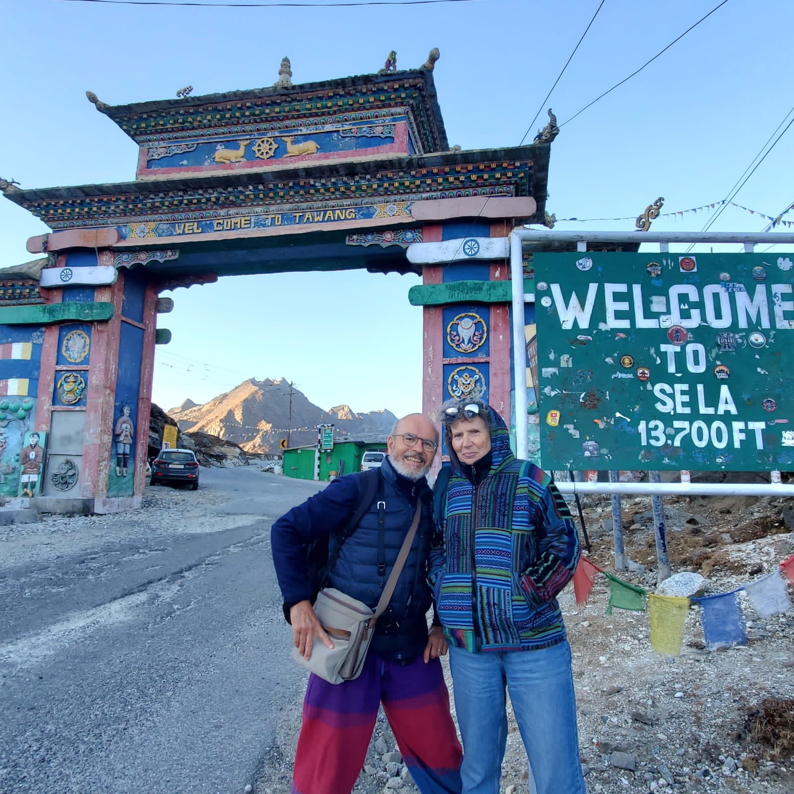 Robert and Odile at the Tawang welcome gate beside the Sela Pass sign at 13,700 ft in Arunachal Pradesh