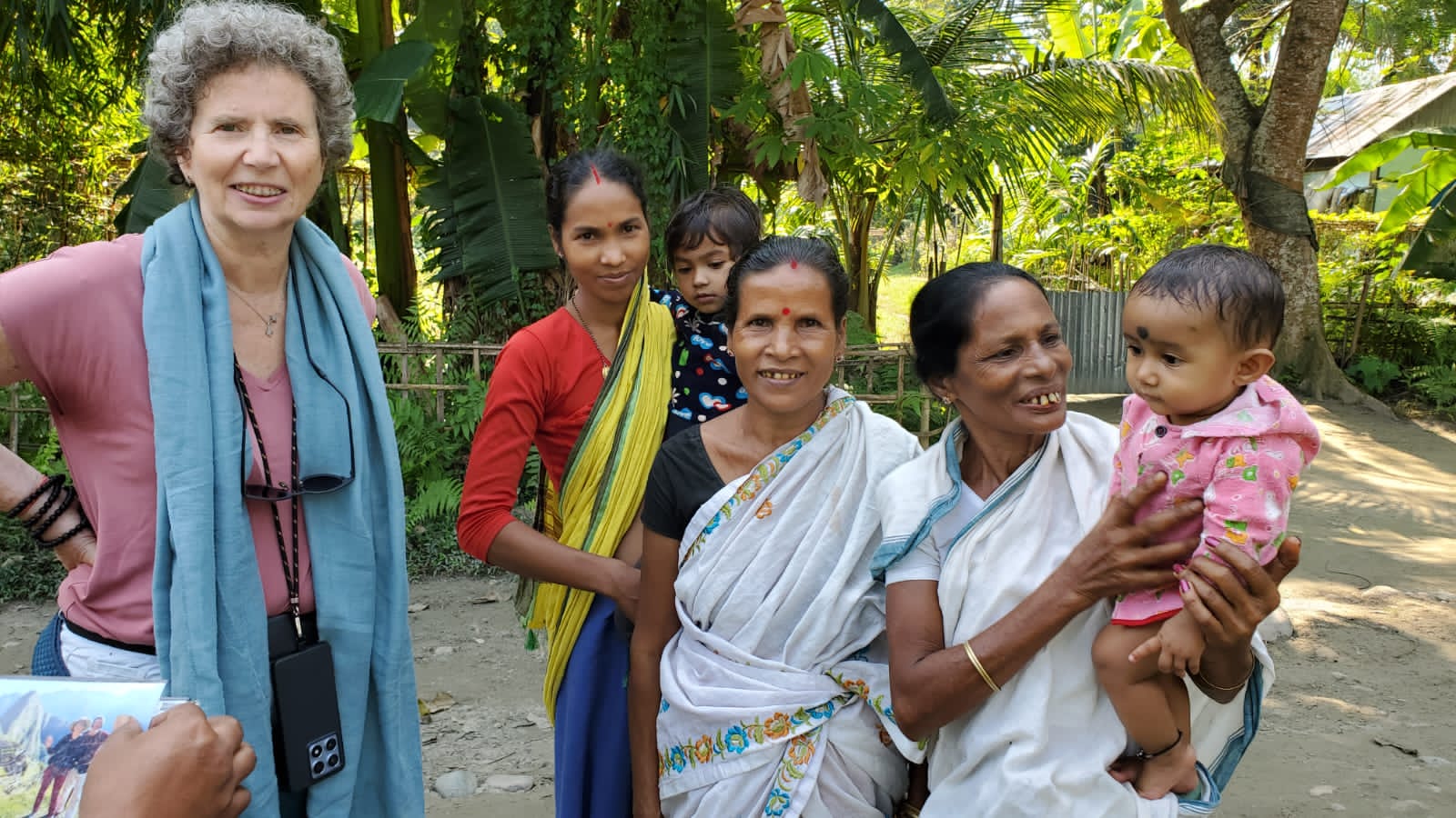 Odile with Assamese village women in mekhela sador holding their children