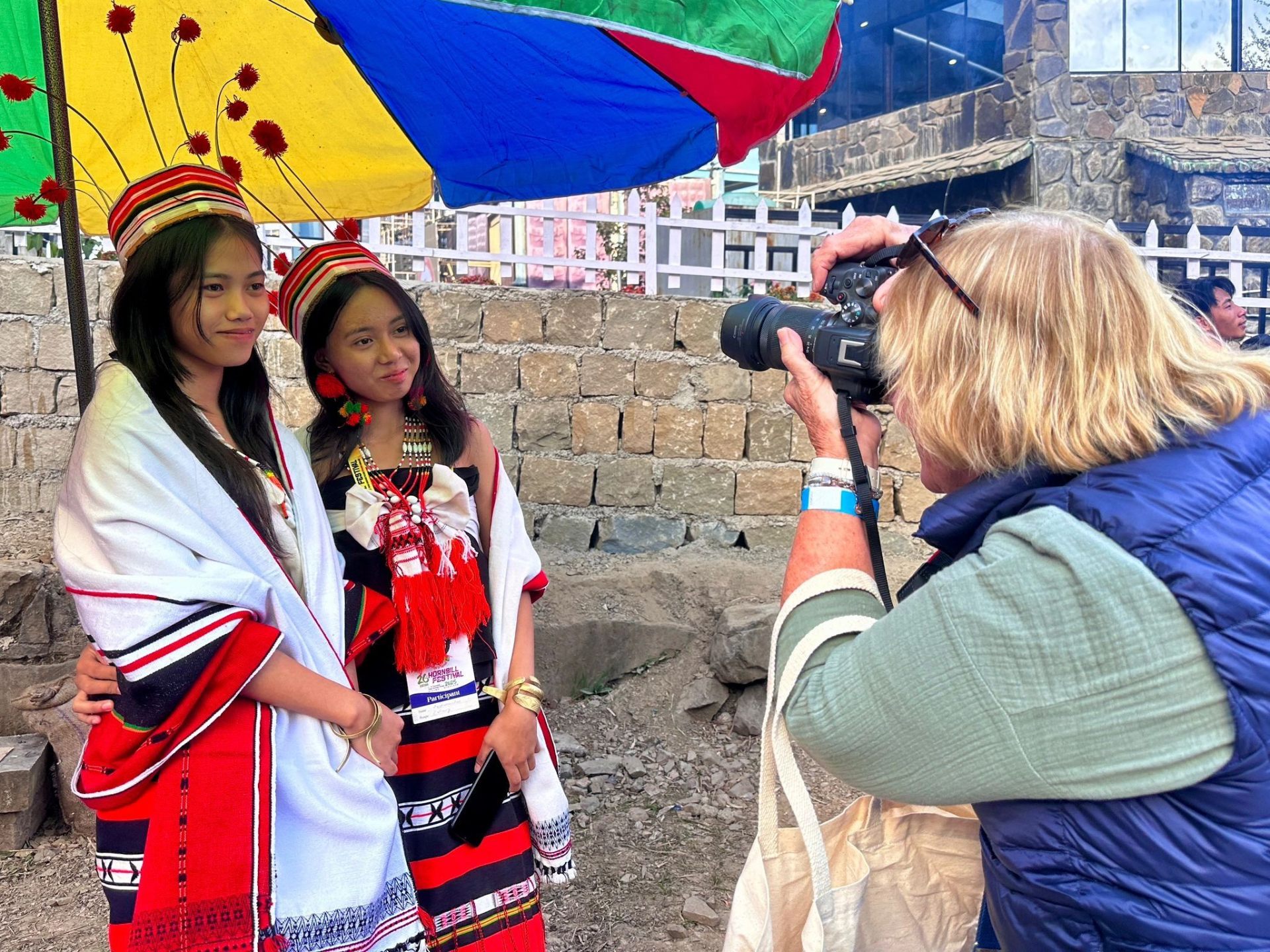 Traveller photographing two young women in traditional Naga attire at the Hornbill Festival
